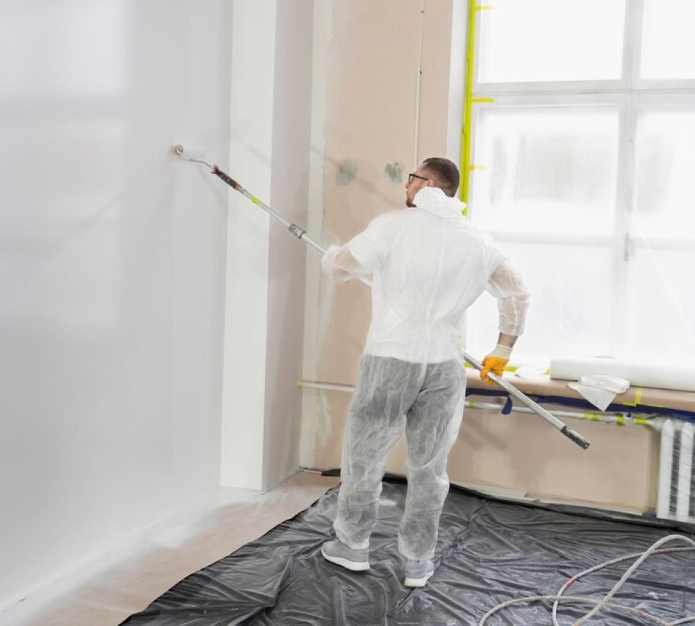 young-worker-painting-wall-full-shot_23-2149344030
